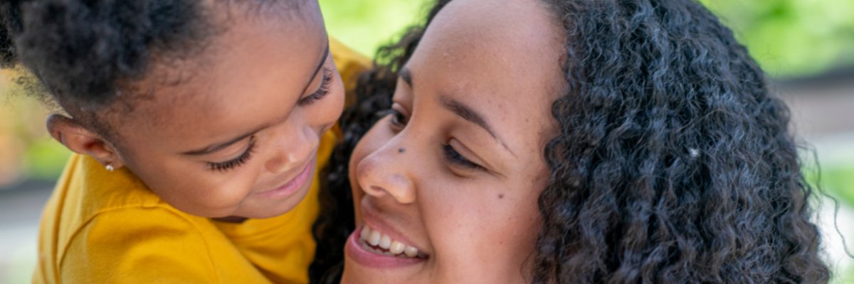 Mother and daughter smiling and looking at one another